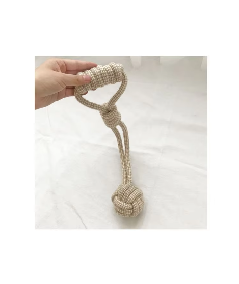 Cotton rope dog toy with a knotted ball on a loop handle, held by the handle
