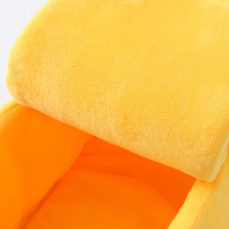 Close view of the padded yellow peel over the orange inside of the banana cat bed