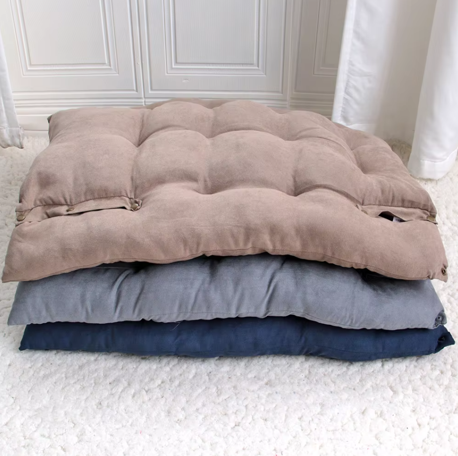 Taupe, grey and navy convertible dog beds stacked flat as mats