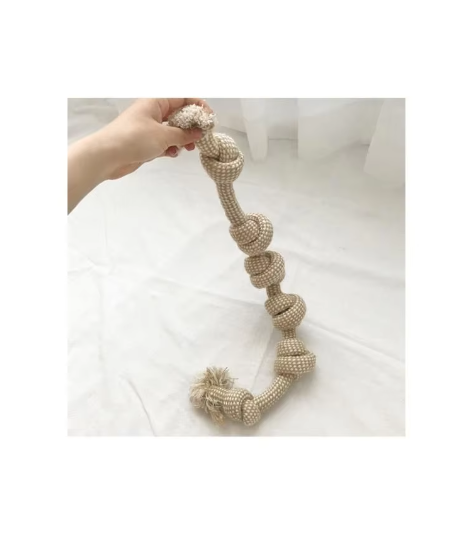 Knotted cotton rope dog toy with a row of knots and frayed ends, held up by one end