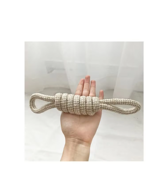 Cotton rope dog toy with two loops joined by a coiled grip, lying across an open hand