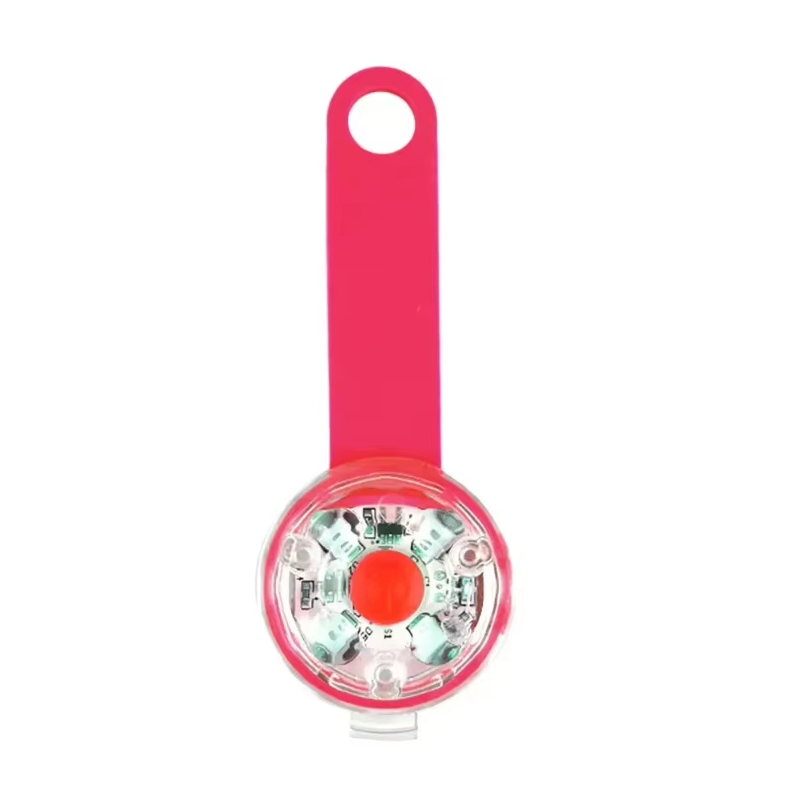 LED collar light with a pink wrap strap and a clear round housing with a red button
