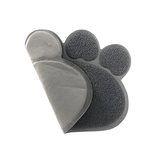 A grey paw-shaped litter mat folded back to show its smooth underside