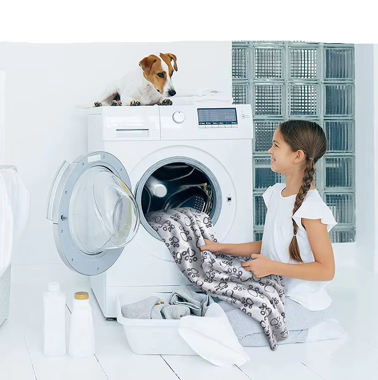 The grey paw print pet blanket being taken out of a washing machine