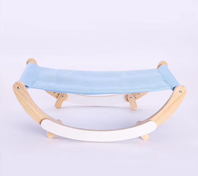 Cat hammock bed with a light blue mesh sling on a pale wooden rocking frame with white rockers