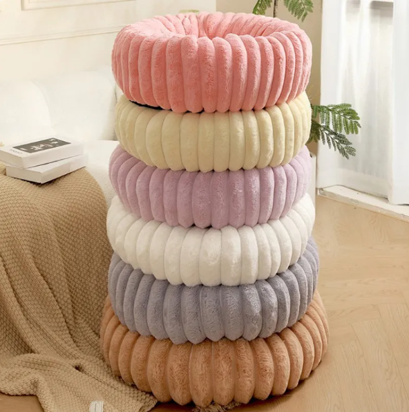 The ribbed donut bed stacked in pink, cream, lilac, white, grey and caramel