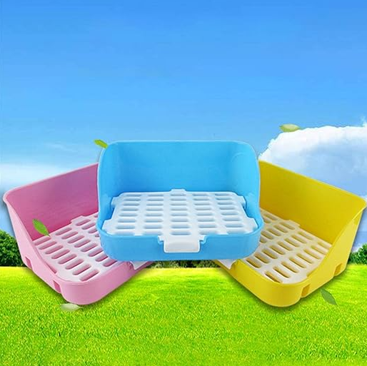 The litter tray in pink, blue and yellow, each with a white grid
