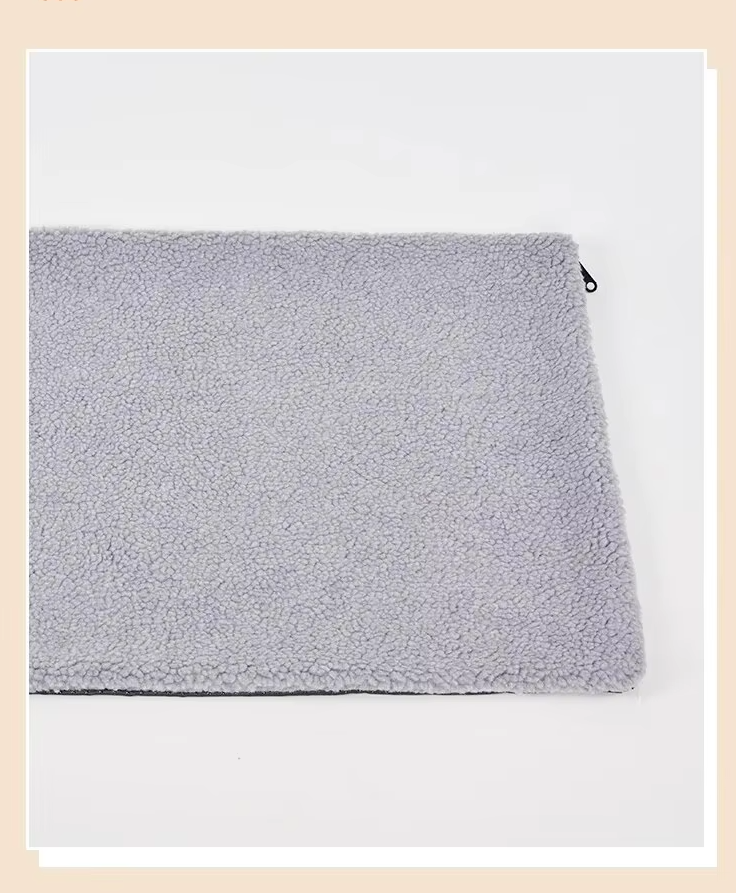 Grey version of the self-warming pet mat lying on a white surface