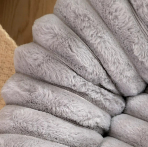 Close view of the long-pile ribbed plush on the grey donut bed