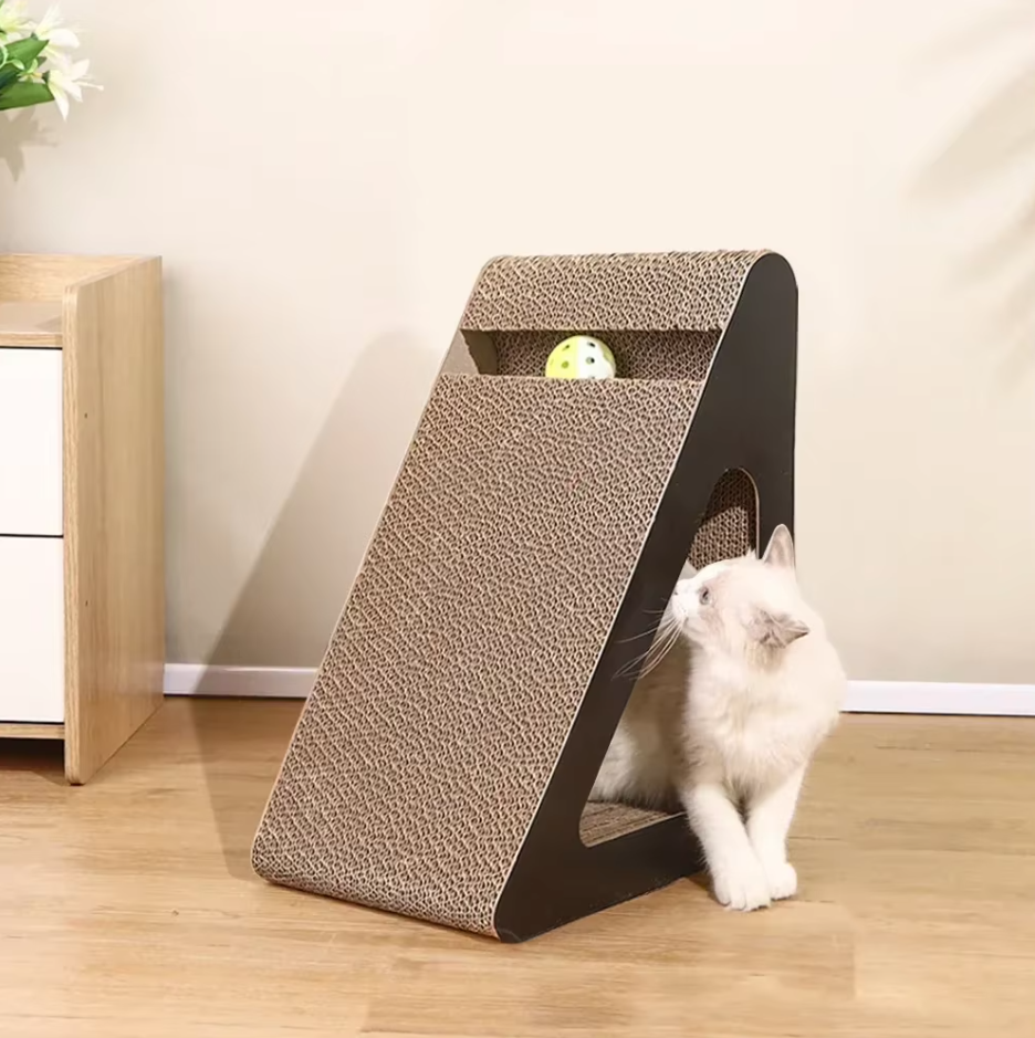 Large triangular cat scratcher with a slot across the top and a side opening, a white cat looking into it