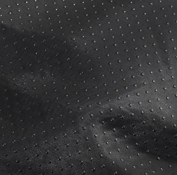 The dark dotted fabric on the underside of the donut bed