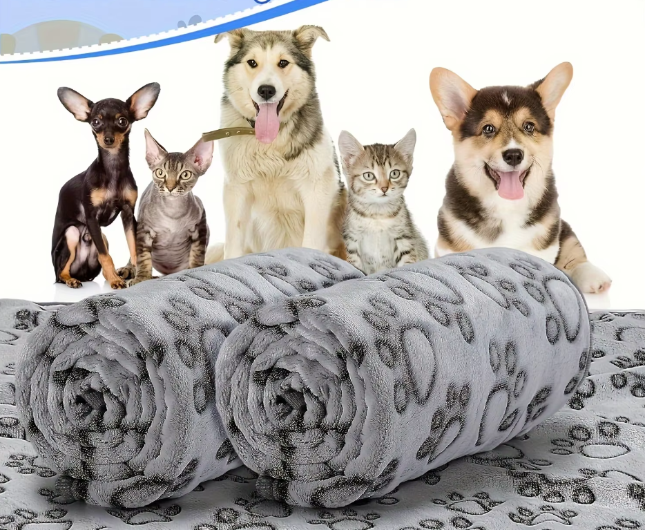 Two rolled grey paw print pet blankets in front of three dogs and two cats