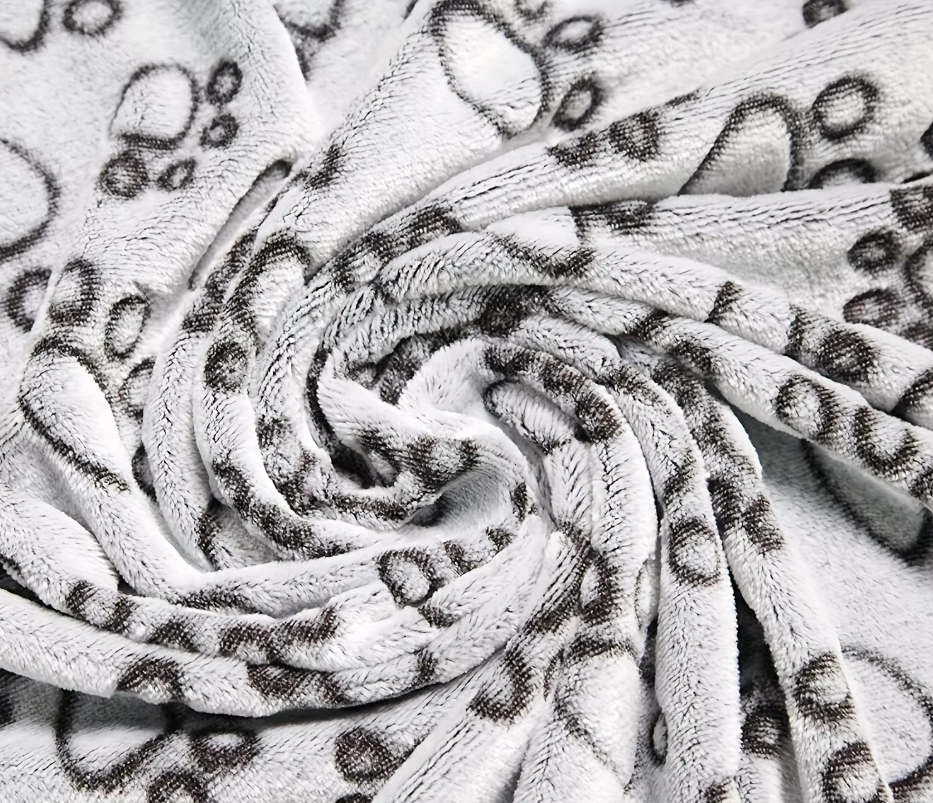Close-up of the soft grey flannel pile with dark grey paw prints