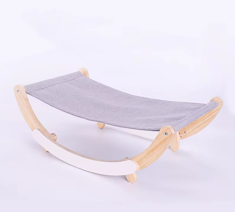 Cat hammock bed with a light grey sling on a pale wooden rocking frame with white rockers