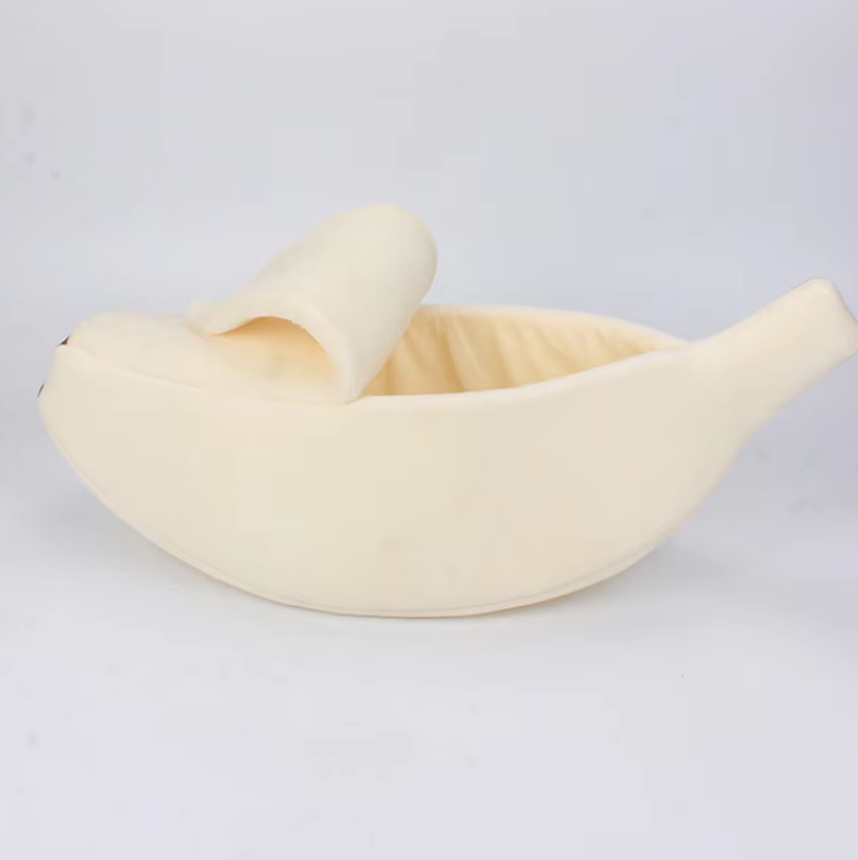 Cream banana cat bed with the peel folded back