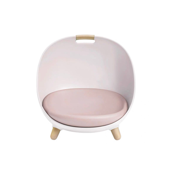 Pale pink egg-shaped cat bed with a pink cushion, wooden legs and a wooden carry grip