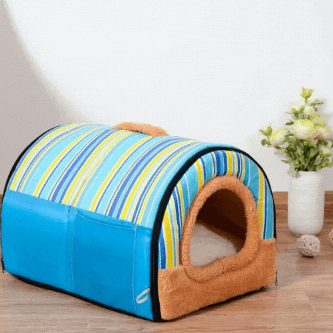 Blue-striped tunnel pet house with blue sides and a tan plush doorway on a wooden floor