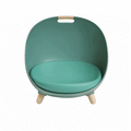 Teal green egg-shaped cat bed with a round cushion, wooden legs and a wooden carry grip