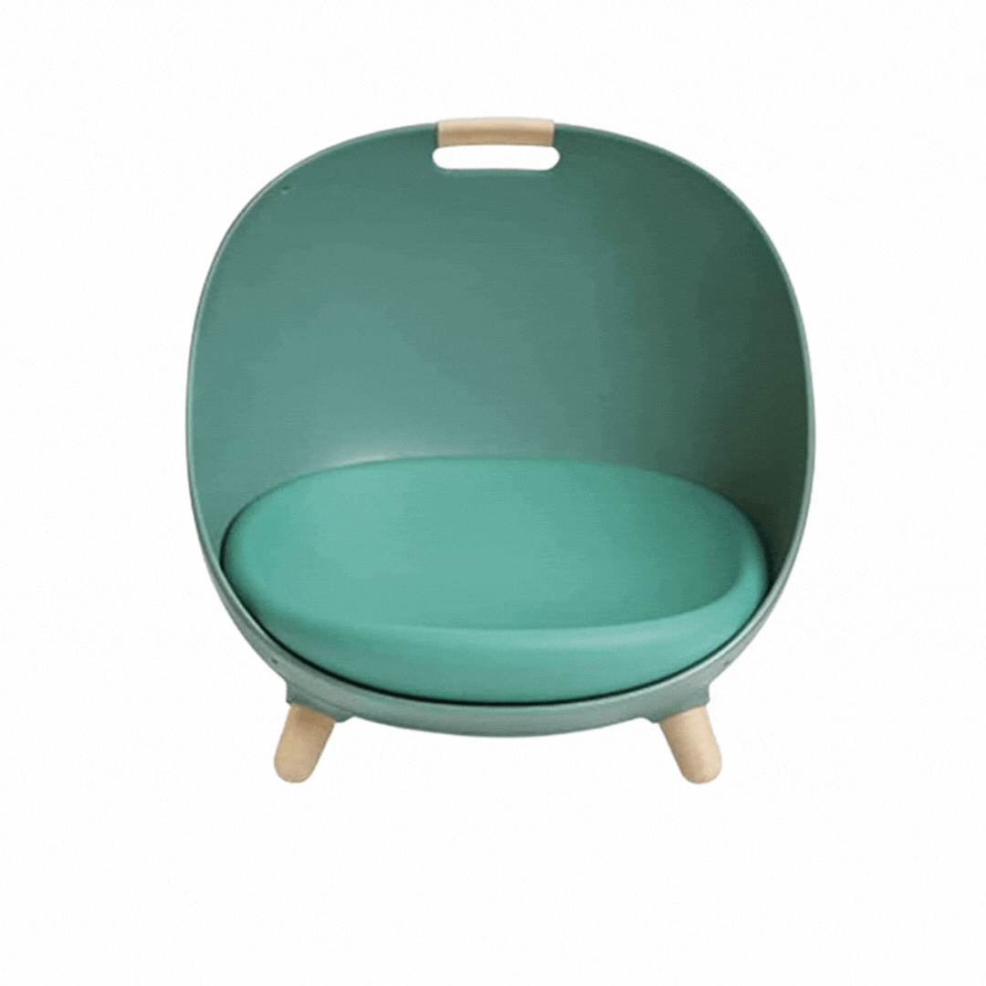 Teal green egg-shaped cat bed with a round cushion, wooden legs and a wooden carry grip