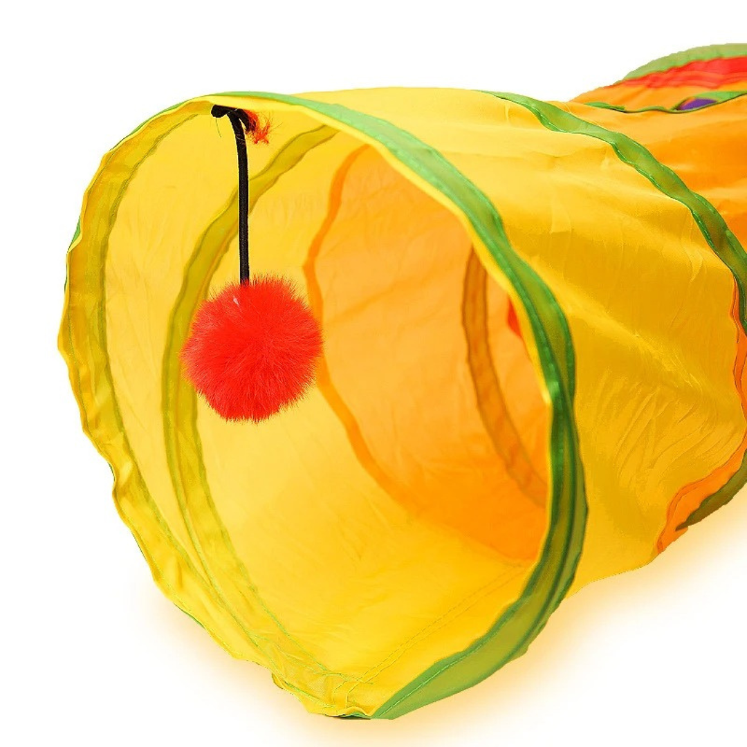 Close view of the rainbow cat tunnel's yellow entrance with the red pom-pom hanging inside