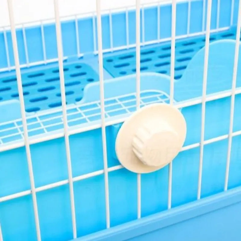 Close view of a blue tray behind white cage bars with a round cream fastener