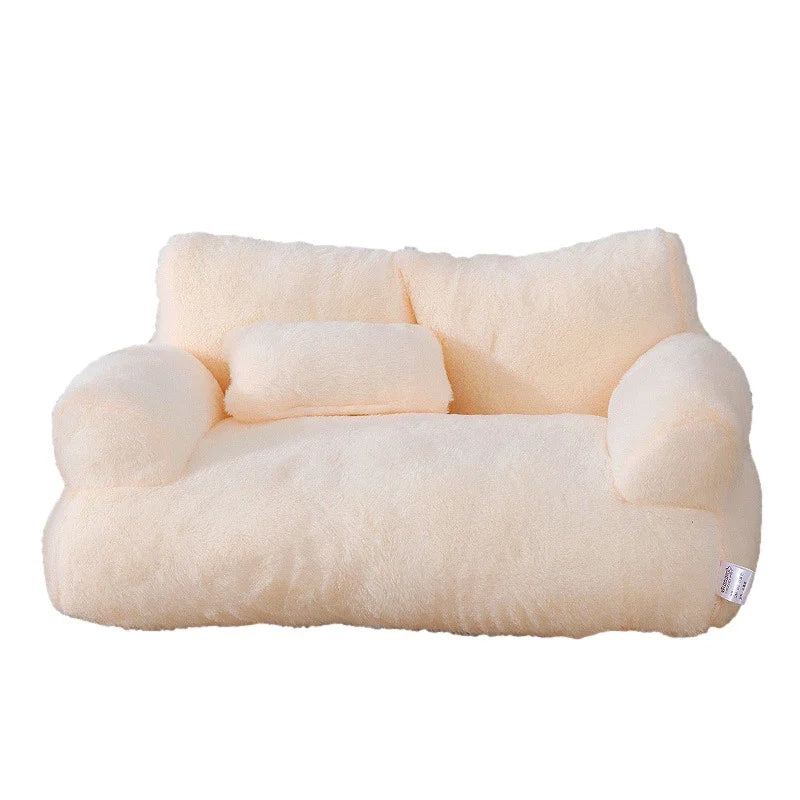 Cream plush dog sofa bed with two armrests and a small pillow