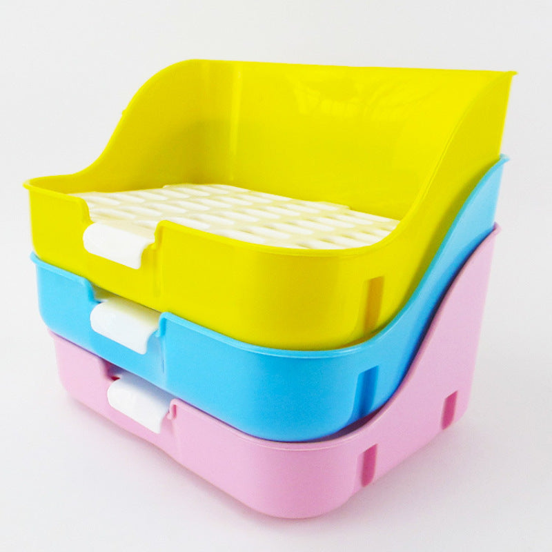 Yellow, blue and pink litter trays stacked, each with a white grid