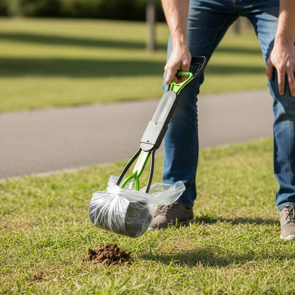 The green scoop with a clear bag over the jaws, on grass