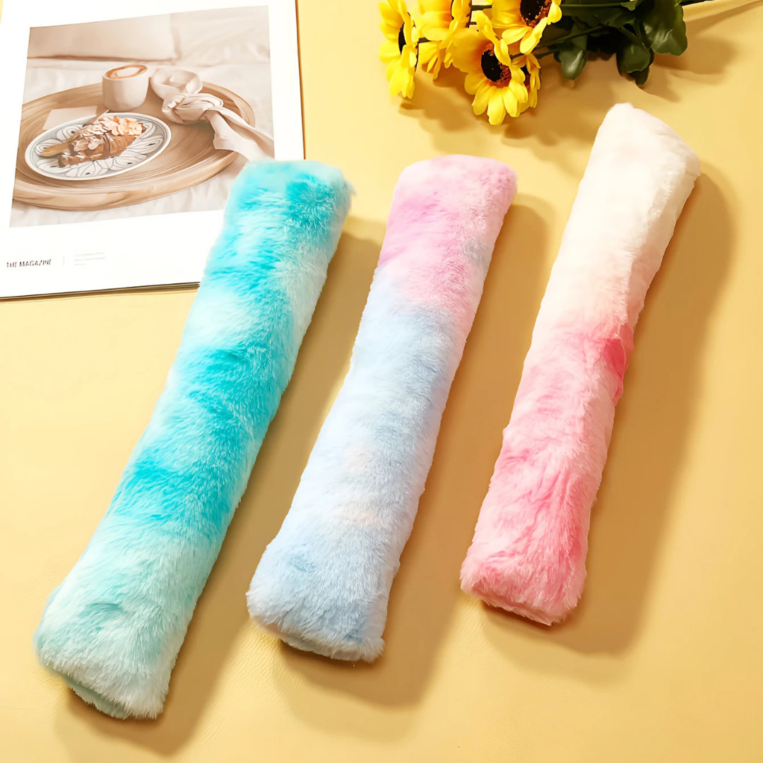 The blue, purple and pink tie-dye catnip kicker pillows side by side