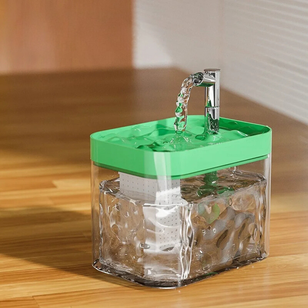Pet water fountain with a clear wave-pattern tank and a green top tray