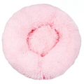 Pink round fluffy donut bed seen from above