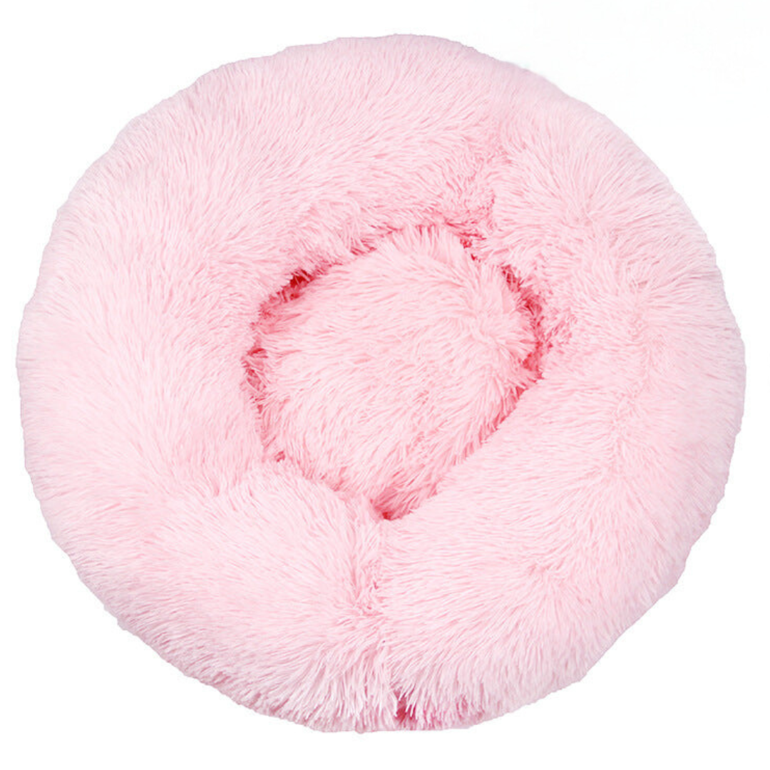 Pink round fluffy donut bed seen from above