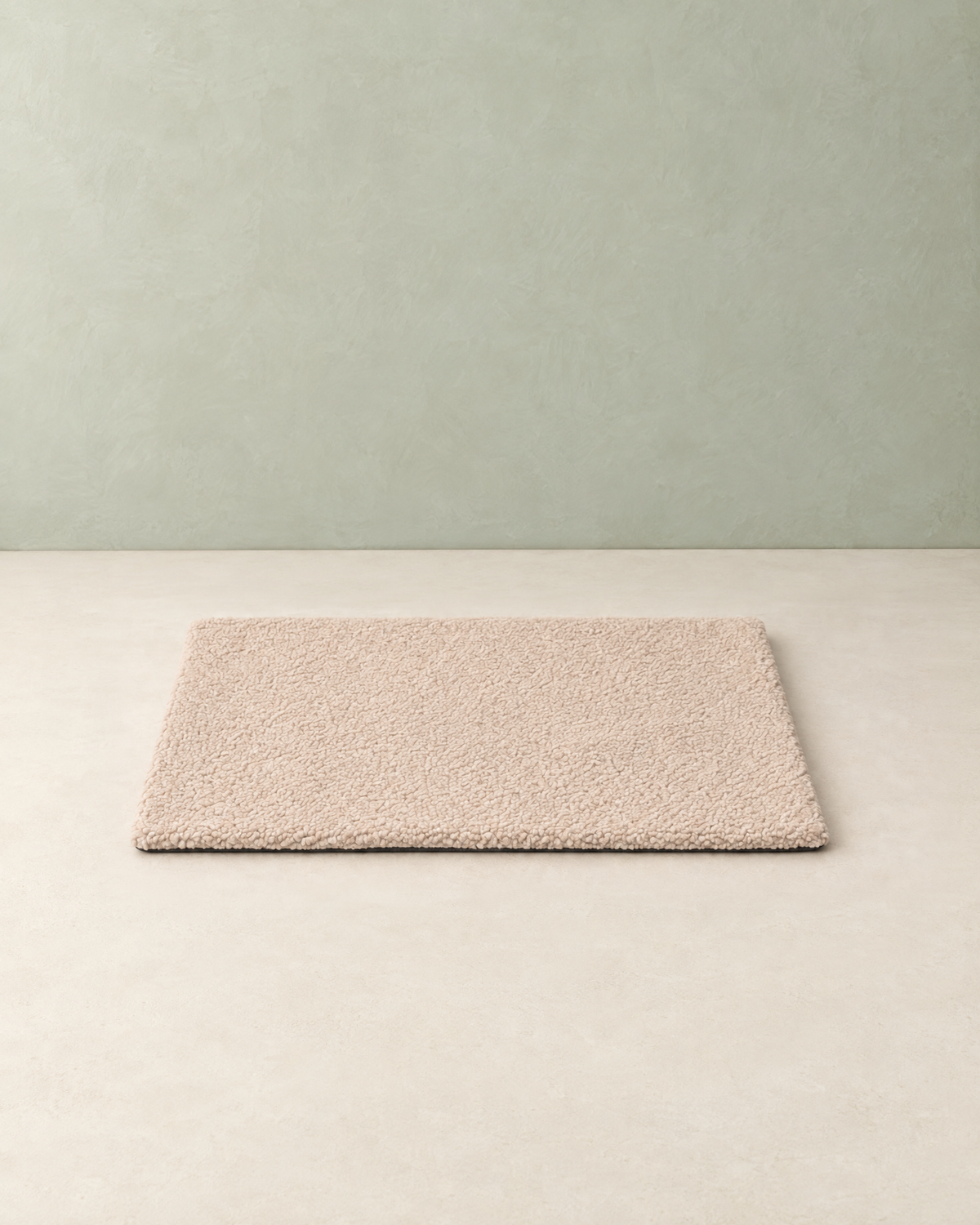 Beige curly-fleece self-warming pet mat lying flat on a cream floor against a pale sage wall