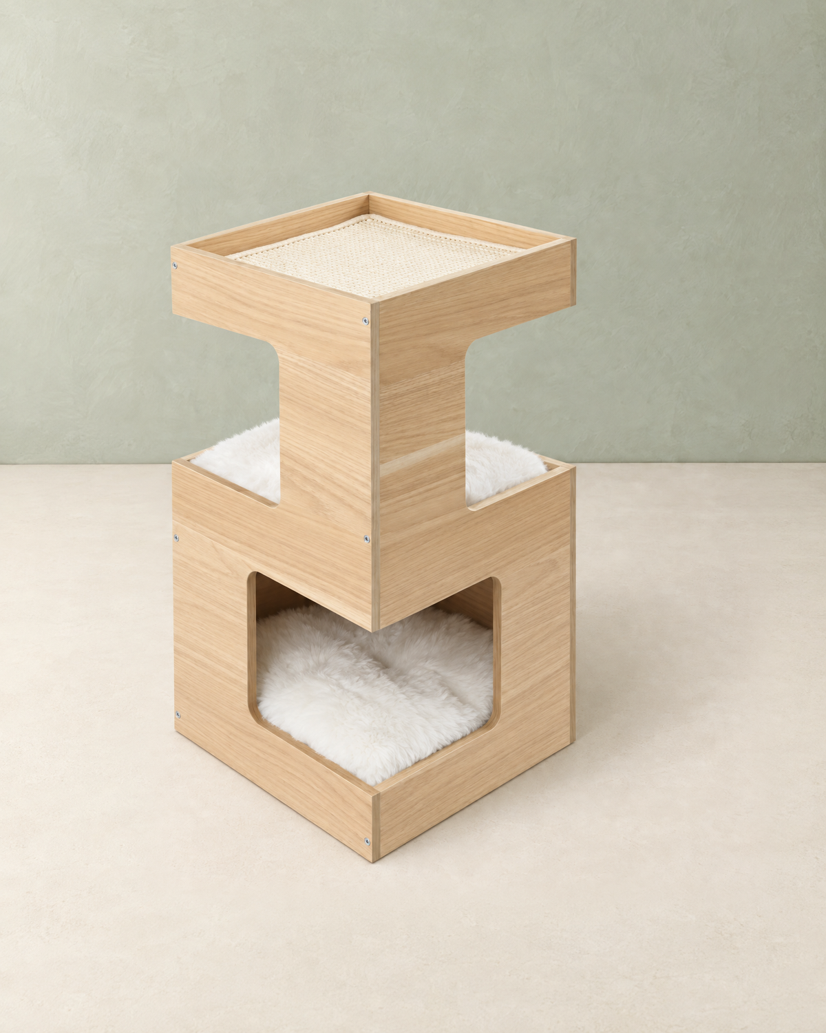Two-tier light oak wooden cat house with a sisal mat in the top tray and white plush beds, on a cream floor against a pale sage wall