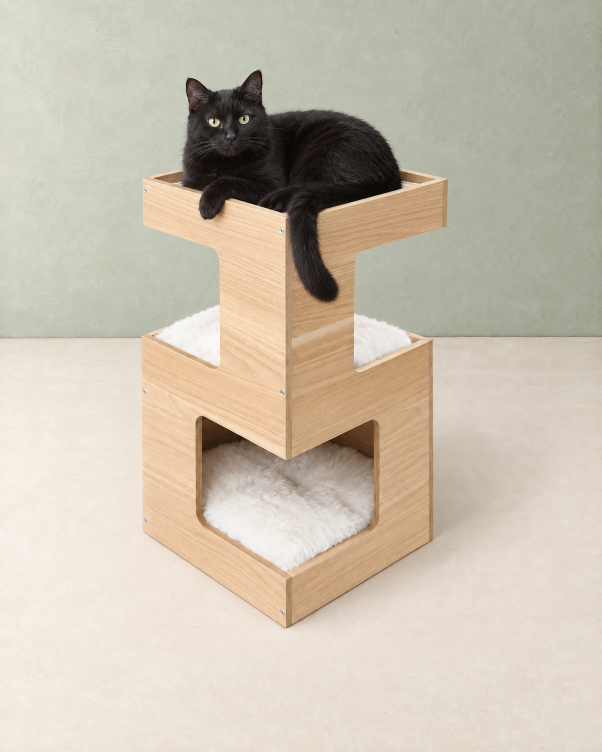 Black cat lying in the sisal top tray of the two-tier wooden cat house