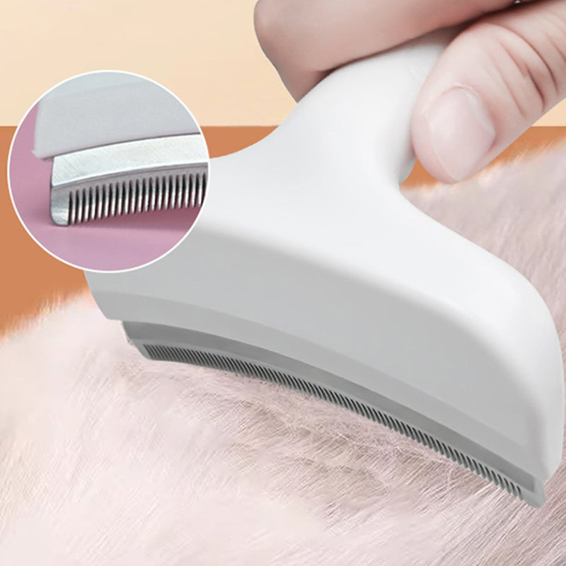 The white deshedding comb drawn through a cat's white coat, with a close view of the fine steel teeth