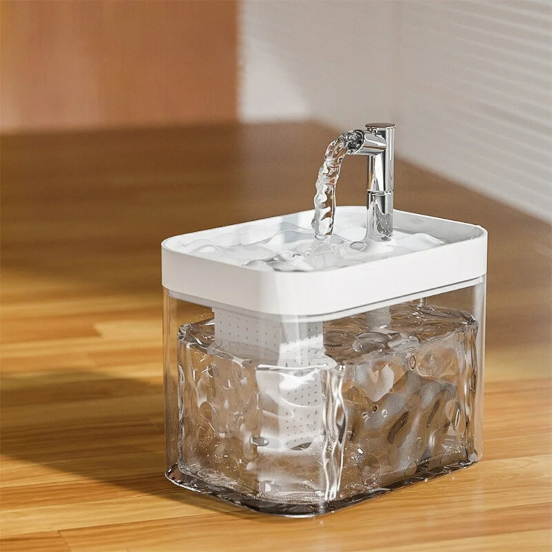 Pet water fountain with a clear wave-pattern tank and a white top tray
